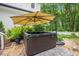 Backyard hot tub with an umbrella for shade and lush landscaping for privacy and relaxation at 5241 Mill Dam Rd, Wake Forest, NC 27587