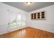 Elegant dining room with hardwood floors, large windows, and classic built-in cabinetry at 5241 Mill Dam Rd, Wake Forest, NC 27587