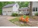 Exterior of house with garage, deck, and chairs in landscaped backyard at 5241 Mill Dam Rd, Wake Forest, NC 27587