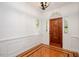 Inviting foyer with beautiful hardwood flooring, trim details, and a wooden front door at 5241 Mill Dam Rd, Wake Forest, NC 27587