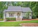 Charming front exterior featuring a well-manicured lawn, inviting porch, and white trim at 5241 Mill Dam Rd, Wake Forest, NC 27587