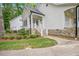 Charming front exterior with stone accents, a well-manicured lawn, and vibrant flower beds at 5241 Mill Dam Rd, Wake Forest, NC 27587