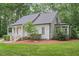 Charming front exterior showcasing a cozy front porch with white columns and meticulous landscaping at 5241 Mill Dam Rd, Wake Forest, NC 27587