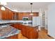 Gourmet kitchen with cherry cabinets, granite countertops, and stainless appliances at 5241 Mill Dam Rd, Wake Forest, NC 27587