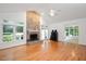 Bright and airy living room with hardwood floors and stone fireplace feature at 5241 Mill Dam Rd, Wake Forest, NC 27587