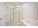 Bathroom showcasing a jacuzzi bathtub with tile surround and a glass shower with tile surround at 5241 Mill Dam Rd, Wake Forest, NC 27587