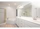 Well-lit main bathroom with double sinks, a soaking tub, and separate shower with glass doors at 5241 Mill Dam Rd, Wake Forest, NC 27587