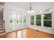 Light-filled sunroom with walls of windows and hardwood floors at 5241 Mill Dam Rd, Wake Forest, NC 27587