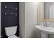 Stylish half bathroom with pedestal sink and modern fixtures at 5310 Echo Ridge Rd, Raleigh, NC 27612