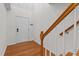 Bright foyer with wood floors, stairs, a coat closet, and a white front door at 5310 Echo Ridge Rd, Raleigh, NC 27612