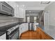 Kitchen with stainless steel appliances and granite counters flowing into the living area at 5310 Echo Ridge Rd, Raleigh, NC 27612