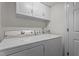 Clean laundry room featuring a modern washer and dryer, and overhead storage for a tidy and efficient space at 5310 Echo Ridge Rd, Raleigh, NC 27612