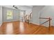 Spacious living room with hardwood floors, neutral walls and staircase at 5310 Echo Ridge Rd, Raleigh, NC 27612