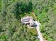 Aerial view of a beautiful home nestled among mature trees on a sprawling lot at 59 Mill Rd, Pittsboro, NC 27312