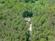 Overhead view of house with driveway in the woods showing the home's location among lush, green trees at 59 Mill Rd, Pittsboro, NC 27312