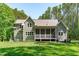 This backyard features a screened in porch and large fire pit at 59 Mill Rd, Pittsboro, NC 27312