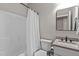 Bathroom includes shower with white curtain, marble vanity top, toilet, and mirrored wall cabinet at 59 Mill Rd, Pittsboro, NC 27312