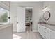 Bright bathroom with vanity, granite counters, modern fixtures, and open doorway to bedroom at 59 Mill Rd, Pittsboro, NC 27312