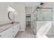 Bathroom featuring a double vanity, black fixtures, and glass-enclosed shower at 59 Mill Rd, Pittsboro, NC 27312