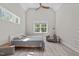 Bedroom featuring high ceilings, two windows, ceiling fan, bed and armchair at 59 Mill Rd, Pittsboro, NC 27312