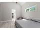Bedroom with vaulted ceiling featuring an entrance to bathroom, armchair, bed, and window at 59 Mill Rd, Pittsboro, NC 27312