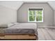 Bedroom with gray comforter and a large window overlooking backyard at 59 Mill Rd, Pittsboro, NC 27312