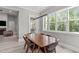 Bright dining room with a large window and a modern light fixture overhead a wooden dining table at 59 Mill Rd, Pittsboro, NC 27312