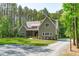 Charming exterior view of a well-maintained home with a lush green lawn and gravel driveway at 59 Mill Rd, Pittsboro, NC 27312