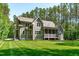 Beautiful home with a large lawn, lush backyard, and a relaxing screened porch at 59 Mill Rd, Pittsboro, NC 27312
