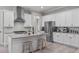 Modern kitchen with stainless steel appliances, large island with seating, and ample counter space at 59 Mill Rd, Pittsboro, NC 27312