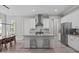 Bright kitchen boasts stainless steel appliances, ample counter space, and a center island with seating at 59 Mill Rd, Pittsboro, NC 27312