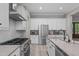Modern kitchen with stainless steel appliances, stone countertops and island cooktop at 59 Mill Rd, Pittsboro, NC 27312