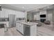 Open concept kitchen views into the living room with stone counters and stainless appliances at 59 Mill Rd, Pittsboro, NC 27312