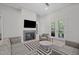 Comfortable living room features a fireplace, stylish furniture and natural light at 59 Mill Rd, Pittsboro, NC 27312