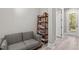 Living Room featuring a grey sofa, a shelf filled with books and an entrance at 59 Mill Rd, Pittsboro, NC 27312