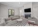 Comfortable living room features fireplace, TV, and warm gray tones creating an inviting space at 59 Mill Rd, Pittsboro, NC 27312