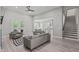 Open-concept living room with sleek furniture, hardwood floors and abundant natural light at 59 Mill Rd, Pittsboro, NC 27312