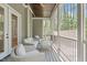 Inviting screened porch features comfortable seating and views of the surrounding nature at 59 Mill Rd, Pittsboro, NC 27312