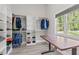 Spacious walk-in closet featuring custom shelving, natural light, and an adjustable table for organizing at 59 Mill Rd, Pittsboro, NC 27312