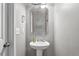 Cozy half bathroom with modern fixtures and a stylish pedestal sink at 59 Nevada Ct, Clayton, NC 27527