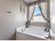 Relaxing soaking tub with stylish curtains in a well-appointed bathroom at 59 Nevada Ct, Clayton, NC 27527