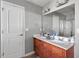 Bathroom with double vanity, spacious mirror, and a glass-enclosed shower at 59 Nevada Ct, Clayton, NC 27527
