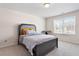 Comfortable bedroom with neutral colors, plush carpeting, and a large window at 59 Nevada Ct, Clayton, NC 27527