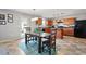 Eat-in kitchen featuring wood cabinets, stainless appliances, an island, and an adjacent dining area at 59 Nevada Ct, Clayton, NC 27527