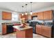 Updated kitchen with stainless steel appliances, center island, and ample cabinet space at 59 Nevada Ct, Clayton, NC 27527