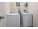 Functional laundry room with a washer, dryer, and metal shelving at 59 Nevada Ct, Clayton, NC 27527