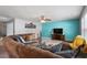 Comfortable living room with plush seating, vibrant accent wall, and ceiling fan at 59 Nevada Ct, Clayton, NC 27527