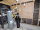 View of basement area, with hot water heater and water filtration system at 6017 Whitaker Ln, Raleigh, NC 27603
