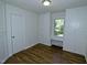 This bedroom features built in cabinets, window seat and hardwood floors at 6017 Whitaker Ln, Raleigh, NC 27603