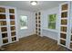 Bedroom with hardwood floors, built-in cabinets and window seats at 6017 Whitaker Ln, Raleigh, NC 27603